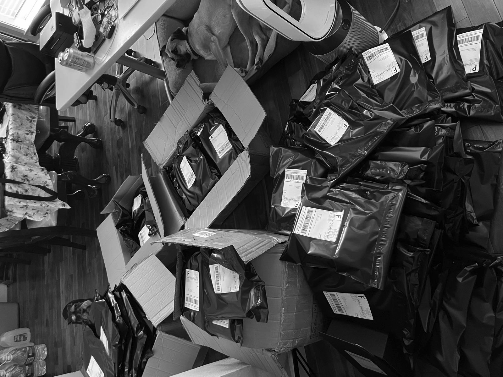 Stacks of black poly mailers labeled and ready to ship.